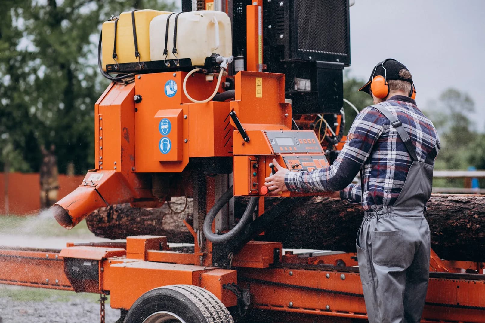 An operator in ear protection running heavy equipment